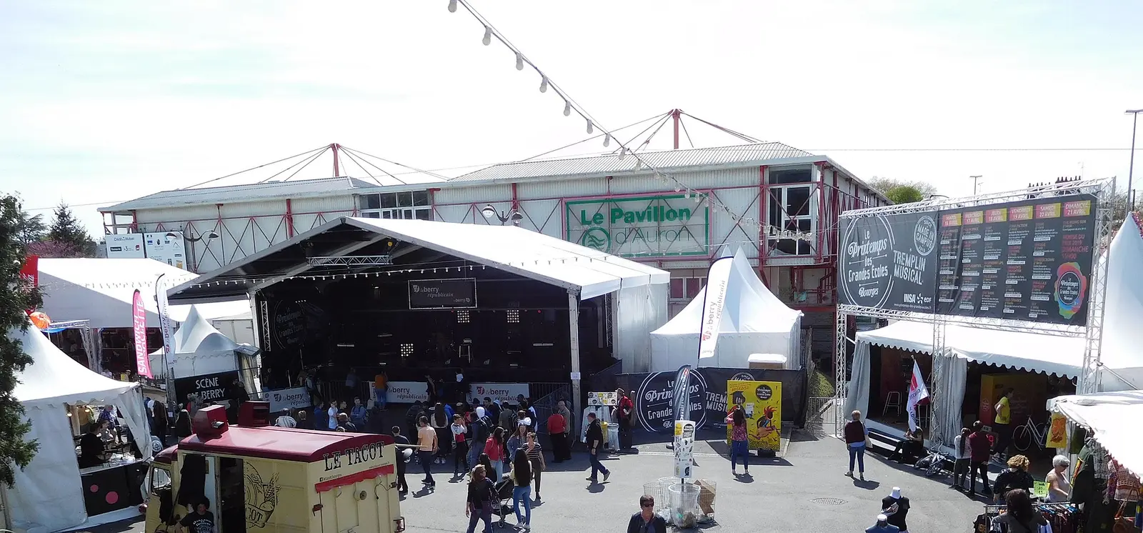 Open-air stage and tents with visitors at the Printemps de Bourges music festival