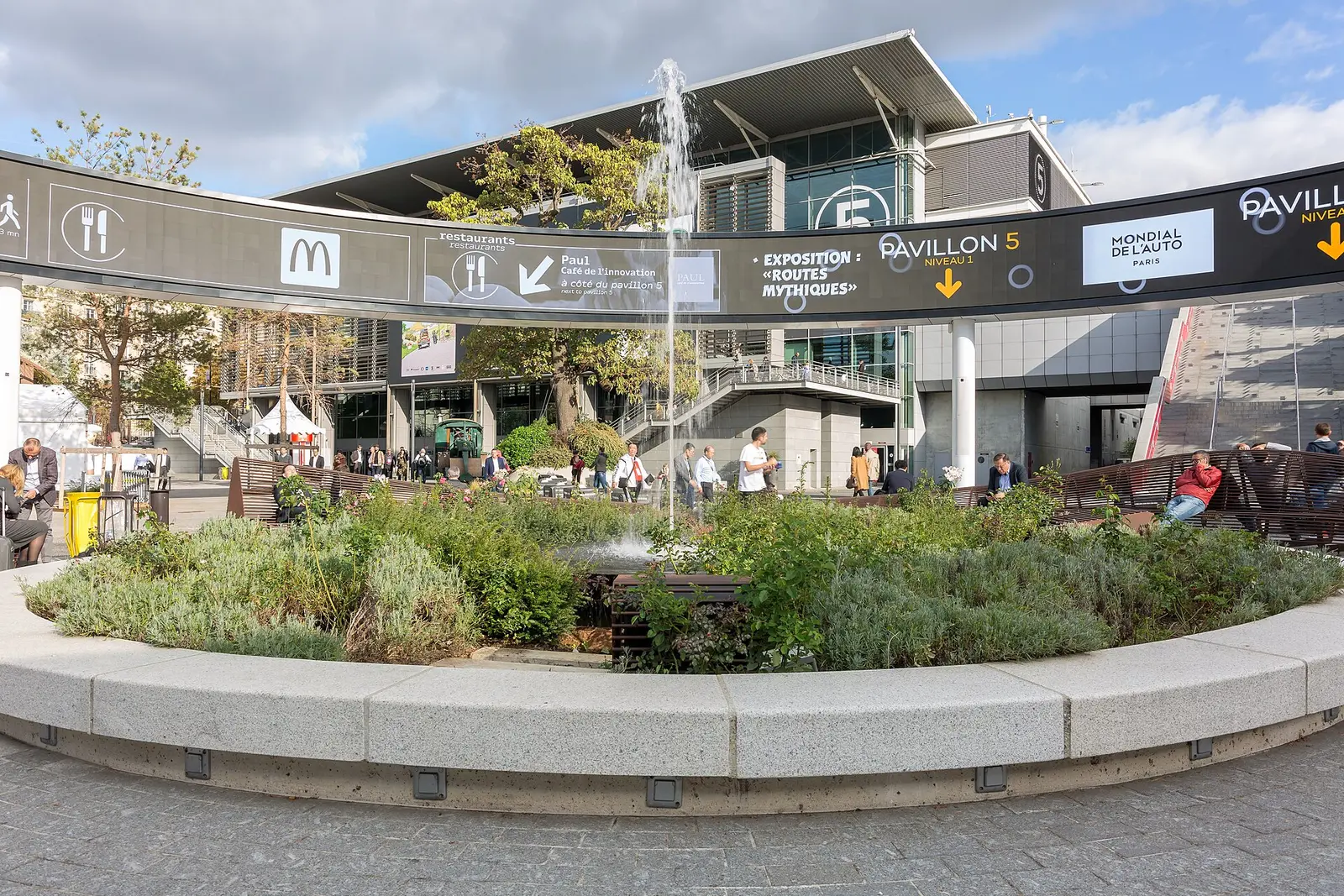 Central square and fountain of Paris Expo Porte de Versailles with visitors