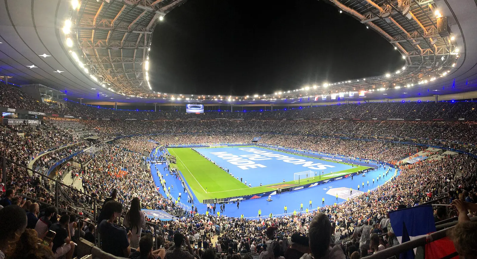 Packed Stade de France under floodlights with the pitch and stands full of spectators