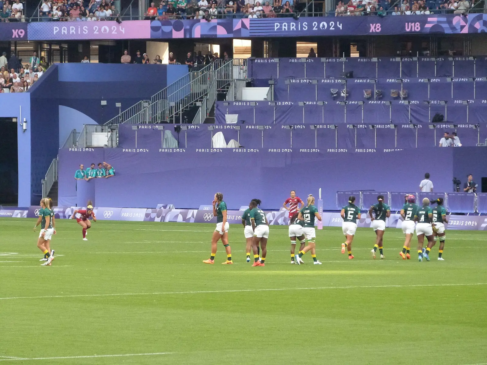 Rugby match on the grass pitch of the Stade de France between Japan and South Africa with stands behind